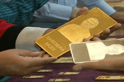 Gold and silver bars with narendra modi embossed on it