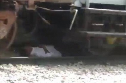 Watch - Andhra man lies down while train passes over him