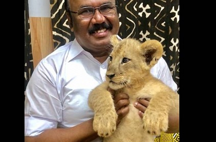 Fishery Minister jayakumar visits japan and holds lion cub writes poem