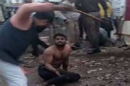 Man brutally caning a person in public as police remains a silent